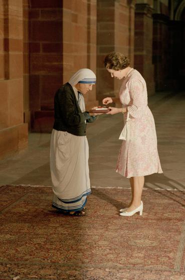 With heads bowed, the Queen and Mother Teresa look at the Insignia of the Honorary Order of Merit which Her majesty has just presented to the Lady of Calcutta, at the Rashtrapati Shavar, in New Delhi, Thursday, November 24, 1983. (AP Photo)